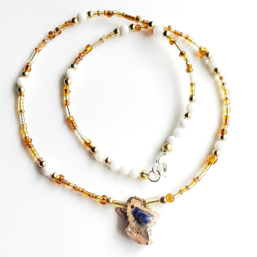 Sodalite crystal on shell with mixed natural earth color based necklace